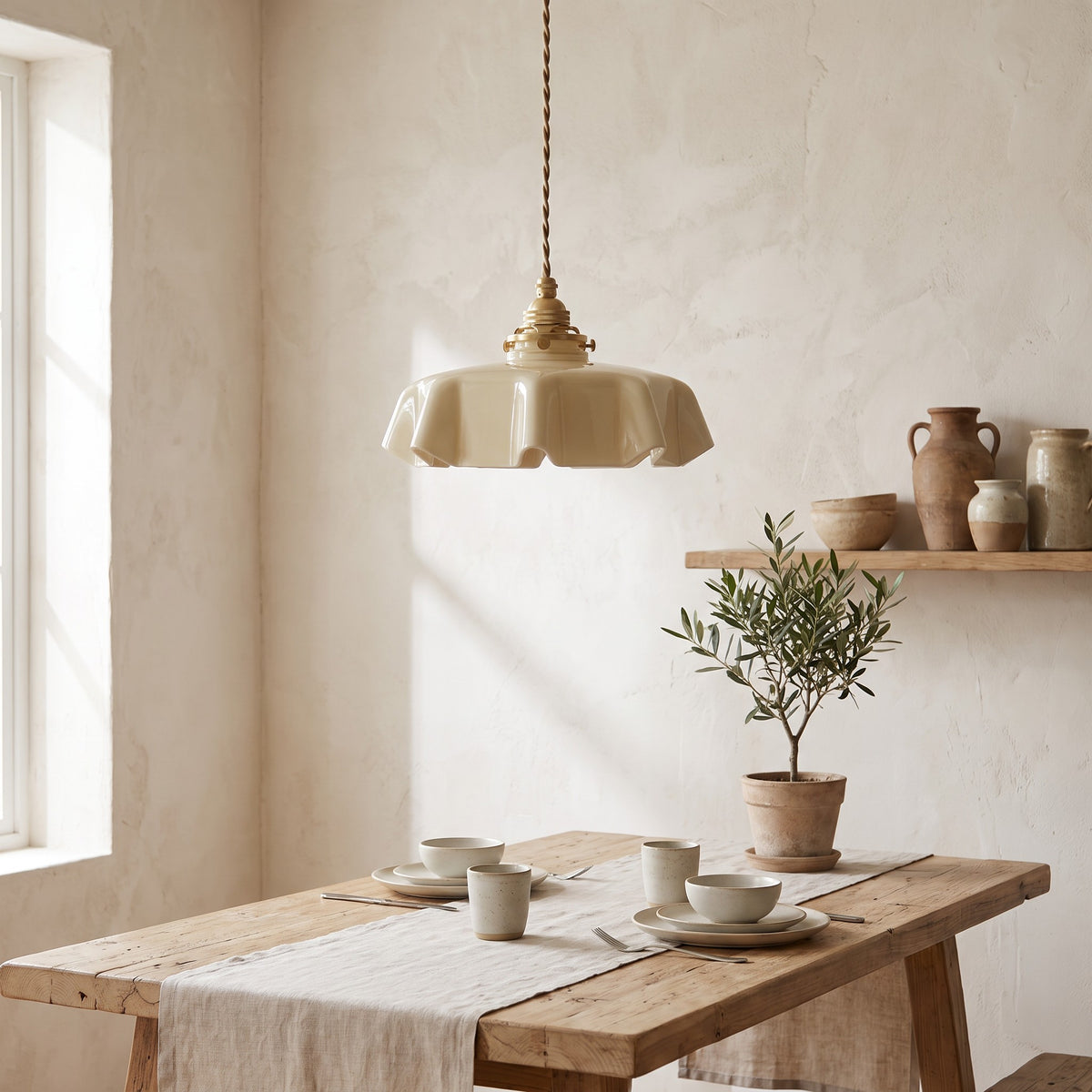 Ronja pendant light in beige glass over a rustic breakfast table