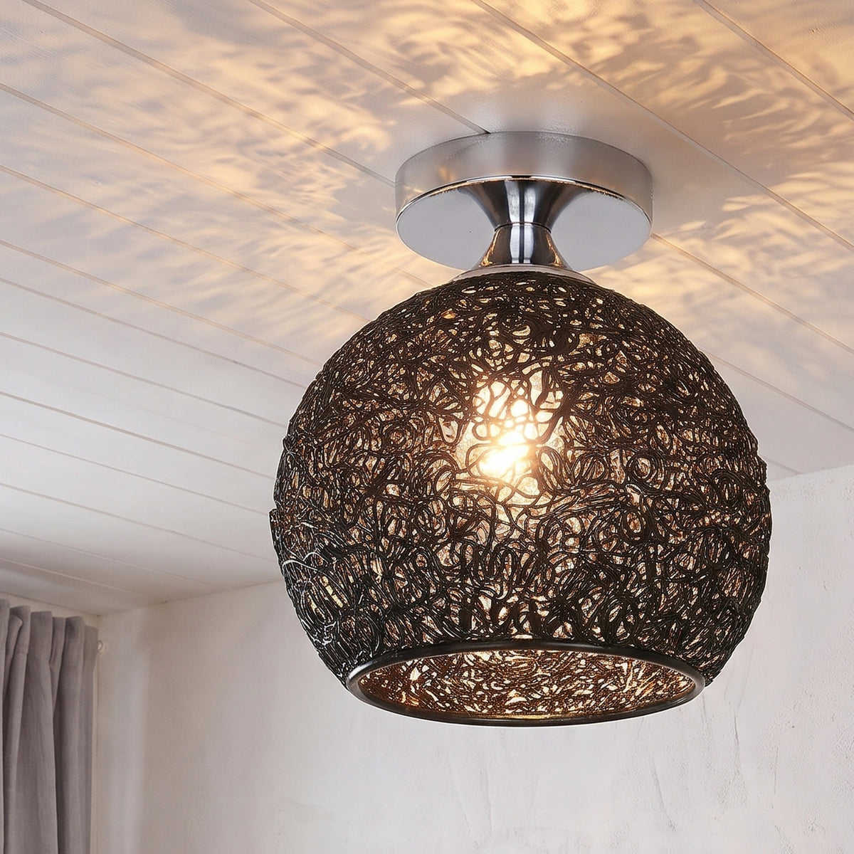 Black Saara wire dome ceiling light lit in the same room