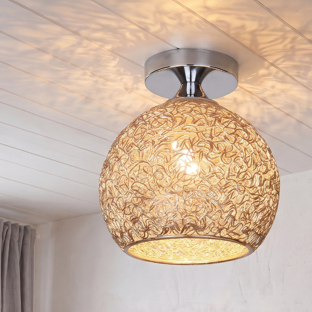 Champagne Saara wire dome ceiling light lit in the same room