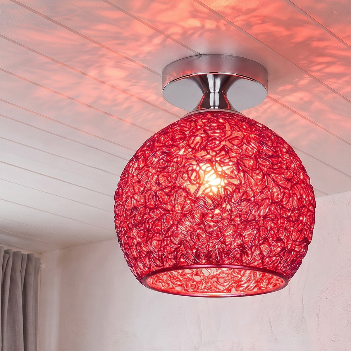 Red Saara wire dome ceiling light lit in the same room