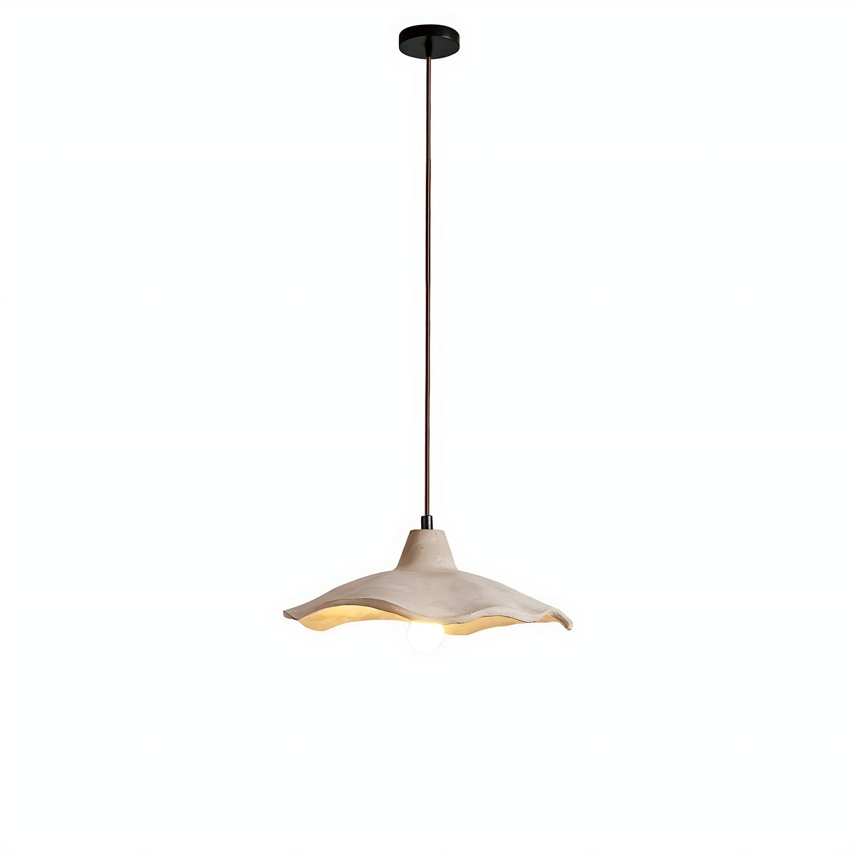 Sanna pendant light with wavy cement shade on its brown cord, lit