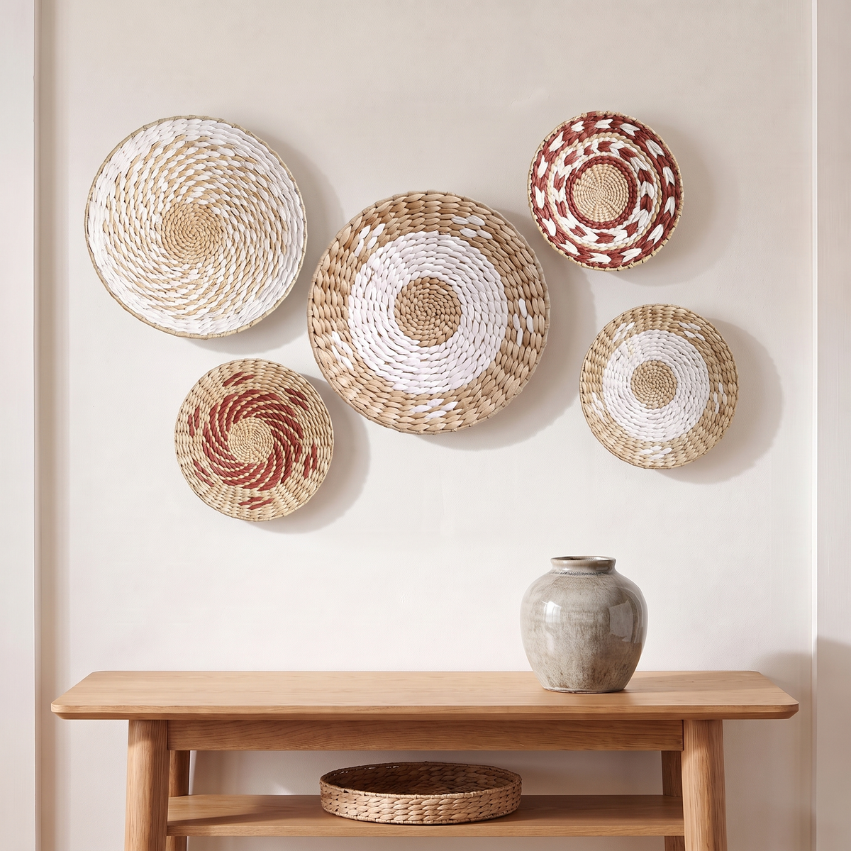 Set of handwoven seagrass wall baskets above a console with a tray basket on the shelf