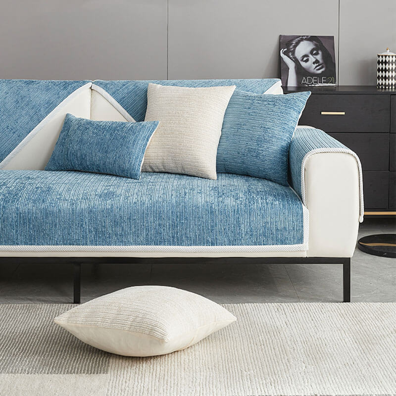 Blue ribbed sofa cover on a white sofa