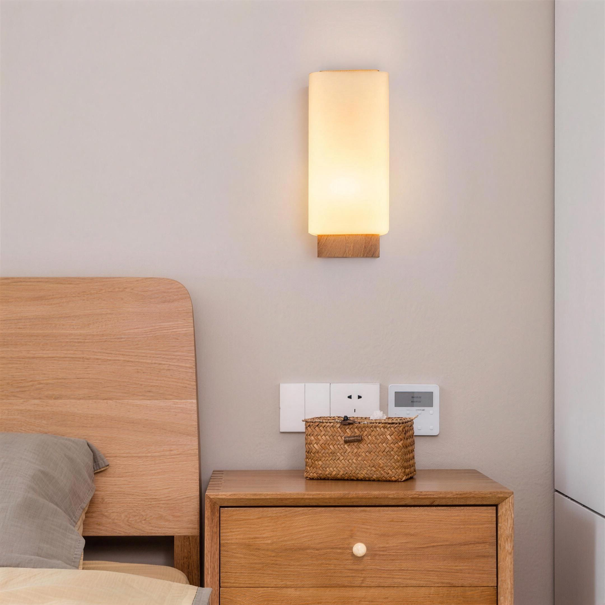 Sofie wall sconce above a nightstand beside a wood bed