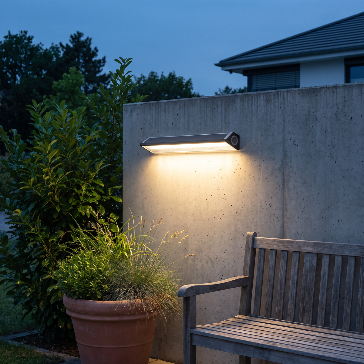 Solar wall light bar on a concrete wall above a wooden bench and a planter