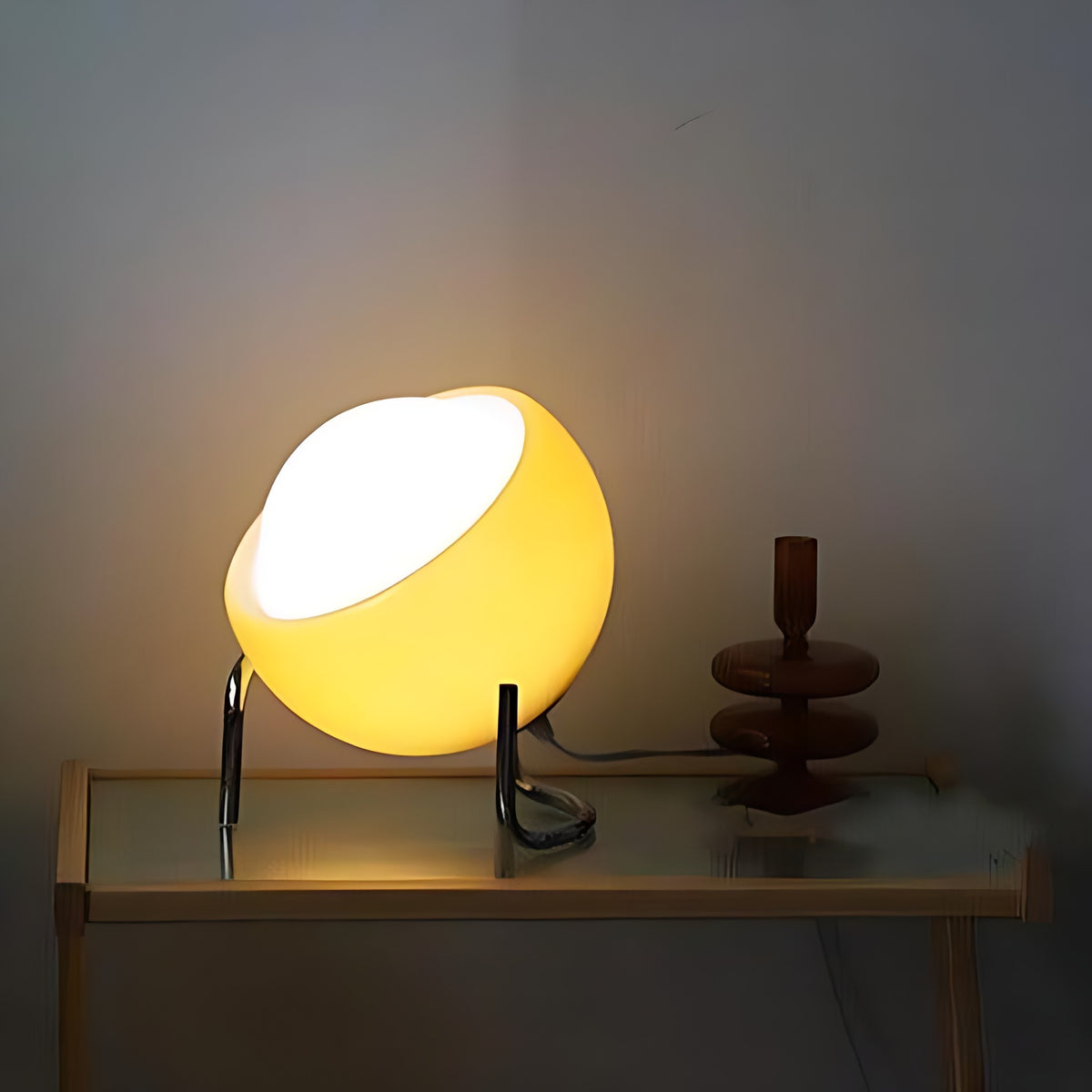 Solveig table lamp lit on a glass top console