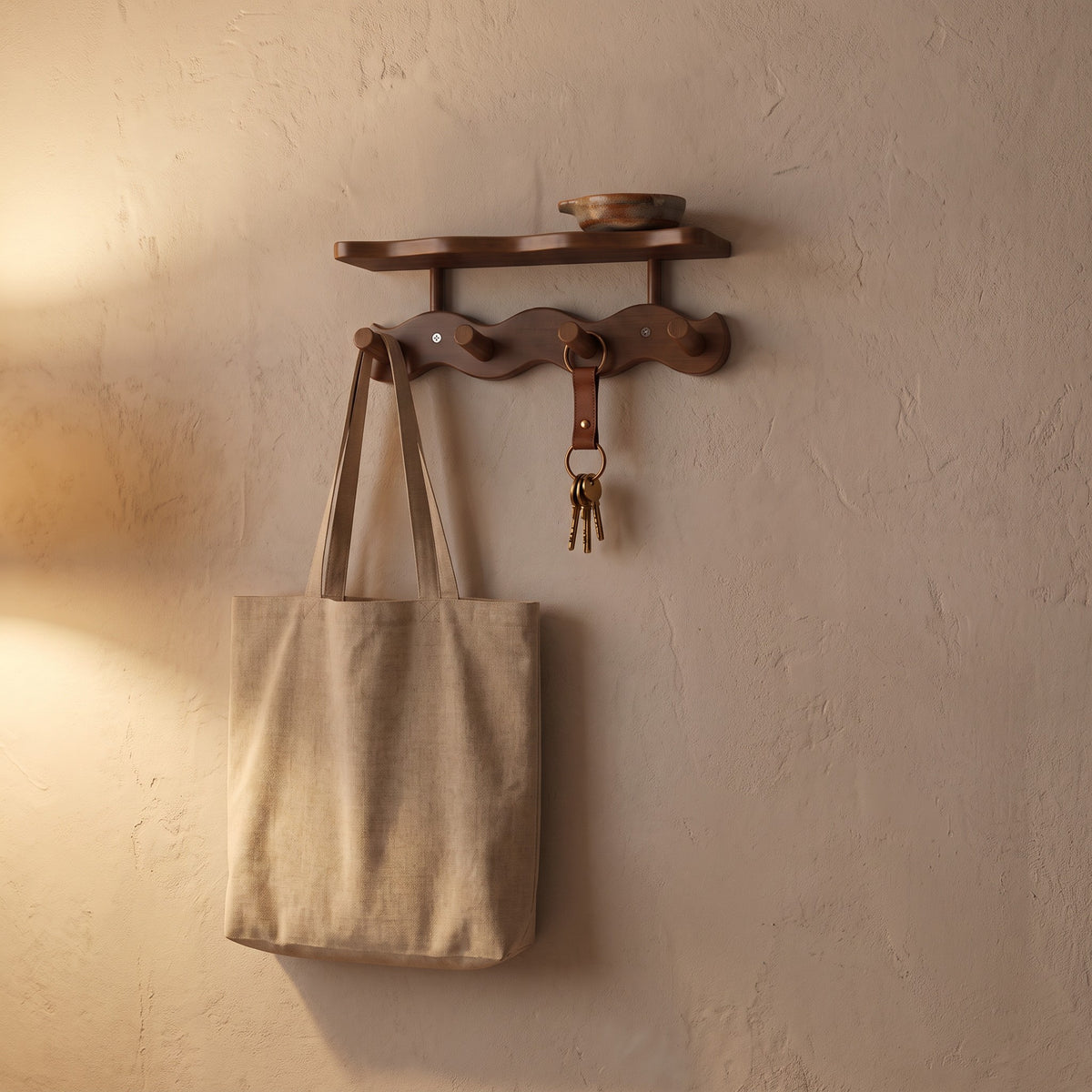 Sonja wall rack in brown with a canvas tote and keys on its pegs on a hallway wall