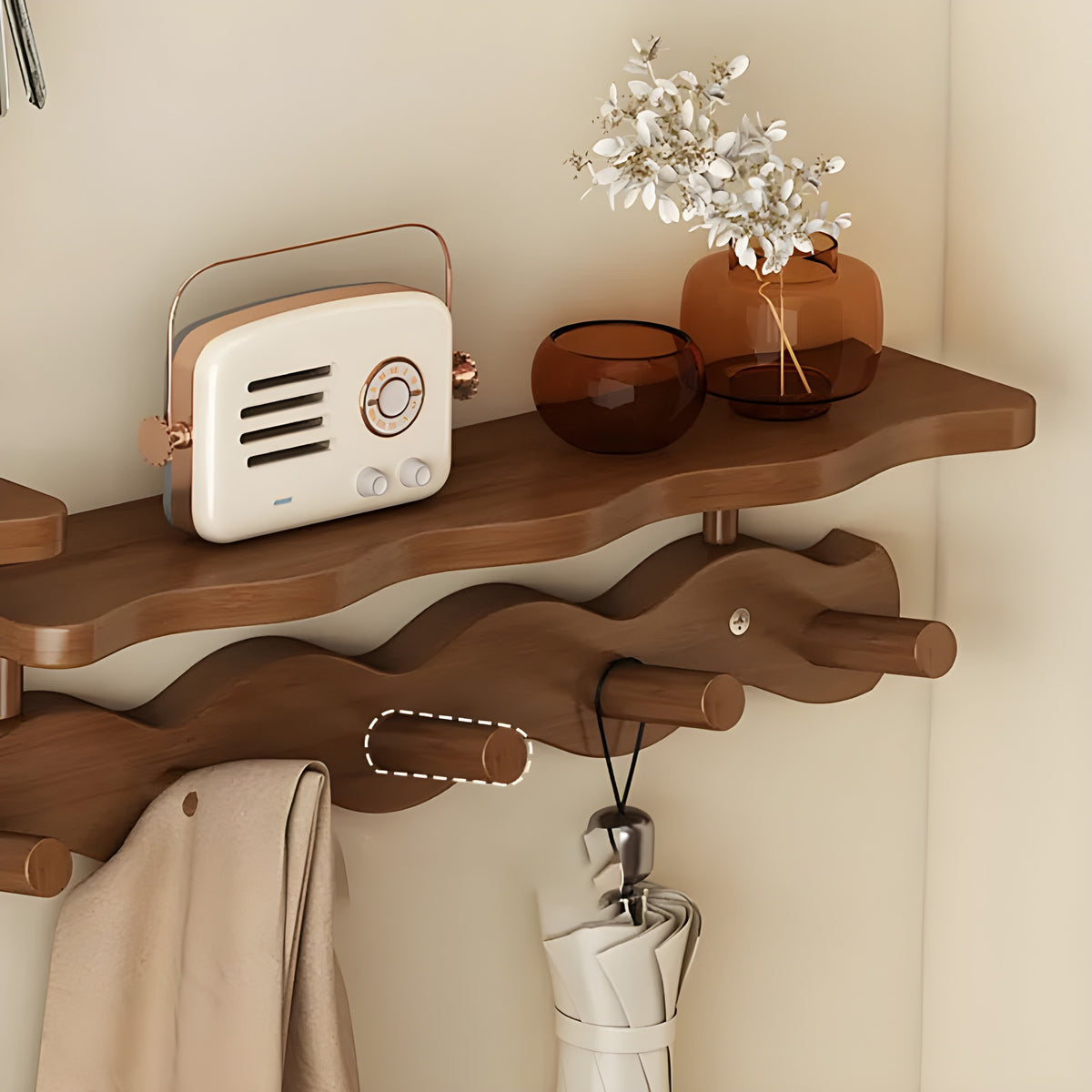 Close view of a bamboo peg and the shelf edge of the Sonja wall rack in brown