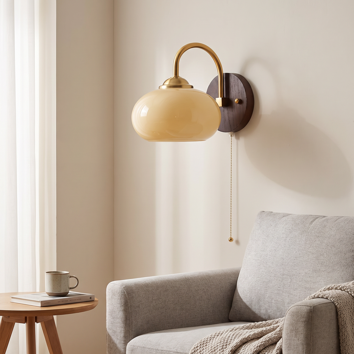 Stina wall sconce in Oval Beige in a living room corner above an armchair