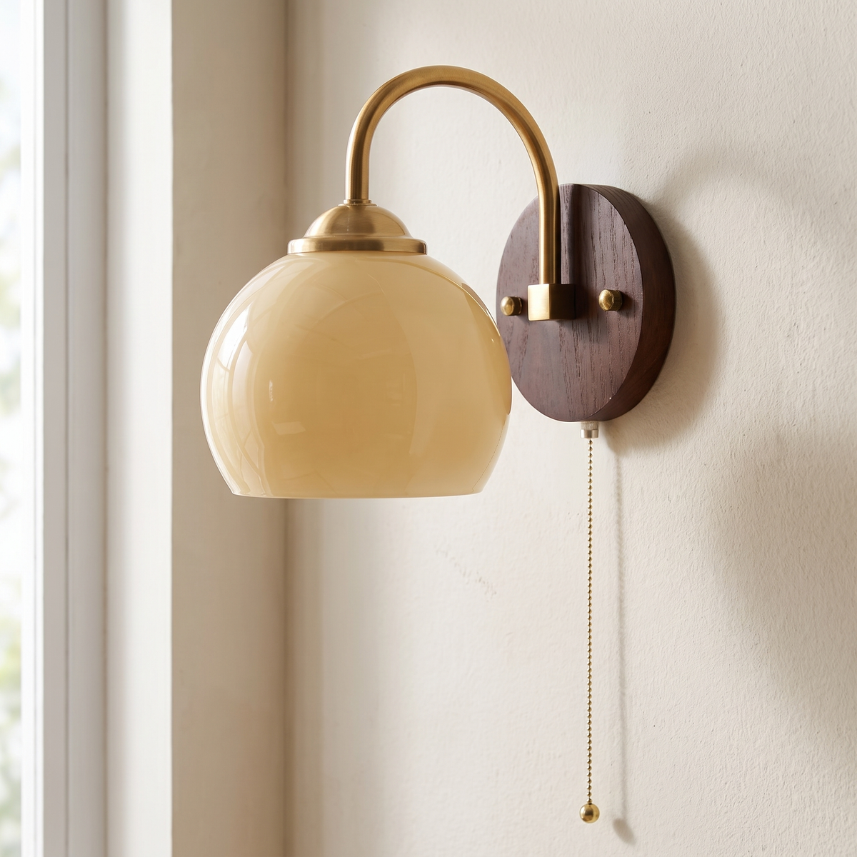 Close view of the Stina wall sconce in Round Beige on a bedroom wall