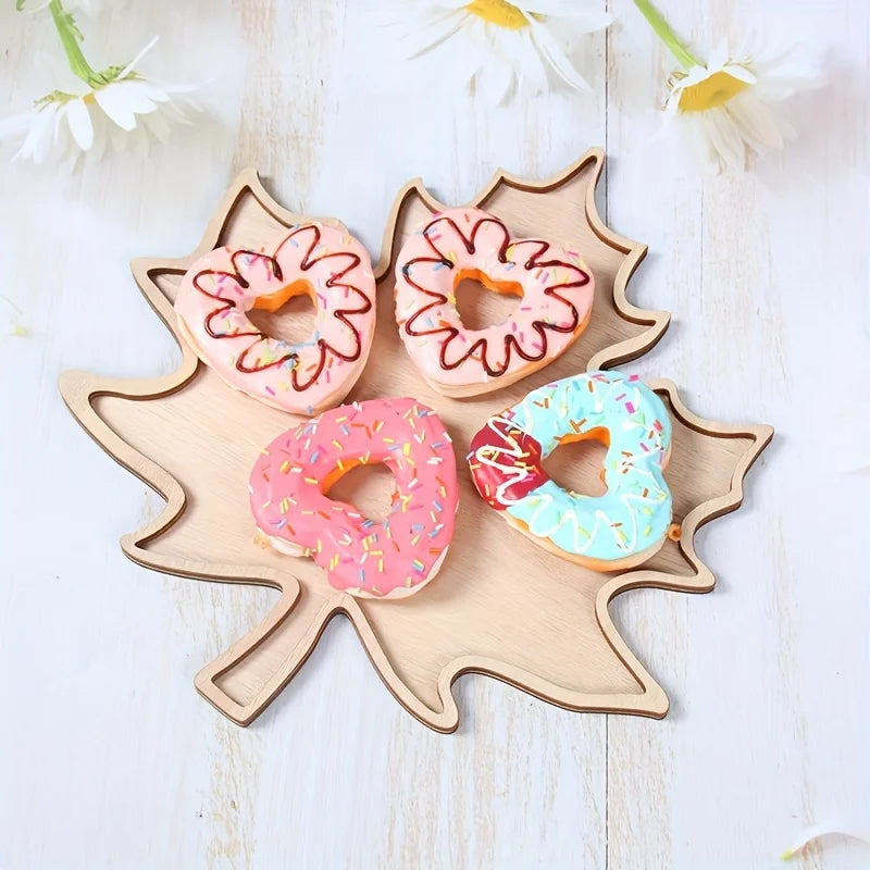 Maple leaf tray holding frosted donuts