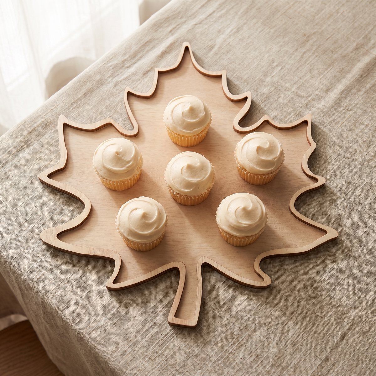 Top view of the Tilde maple leaf tray with six frosted cupcakes