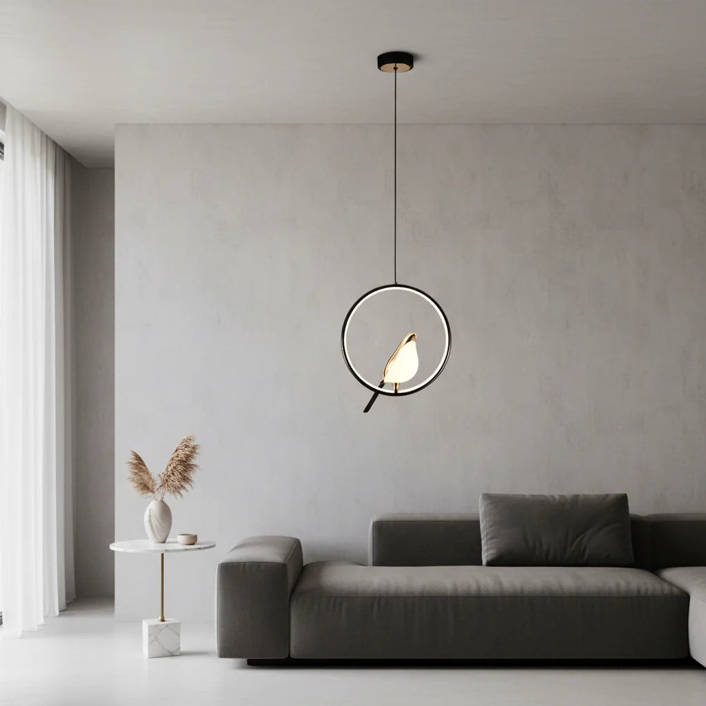 Black ring bird pendant hanging above a dark gray sofa in a pale gray living room