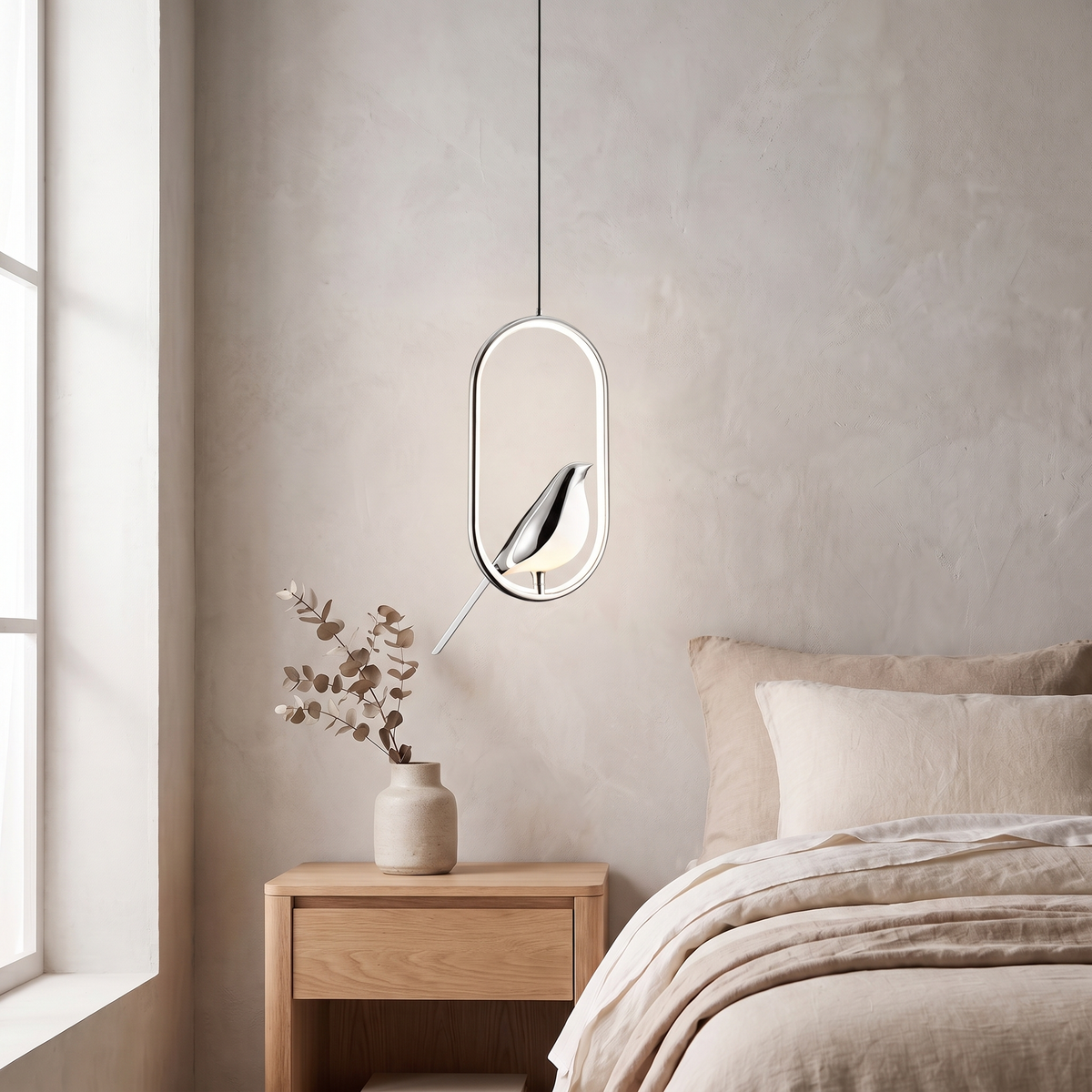 Tind bird pendant light, silver oval frame, above an oak nightstand