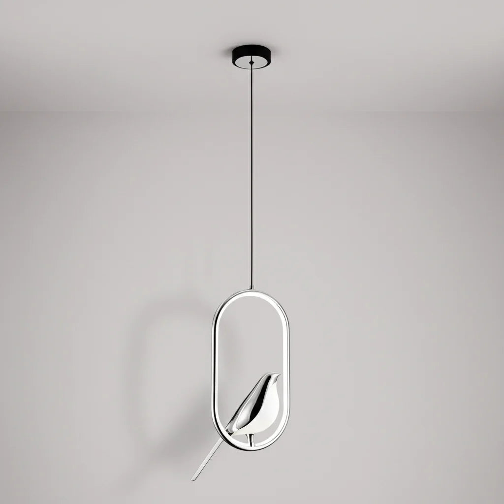 Silver oval frame bird pendant with a silver bird against a pale gray wall