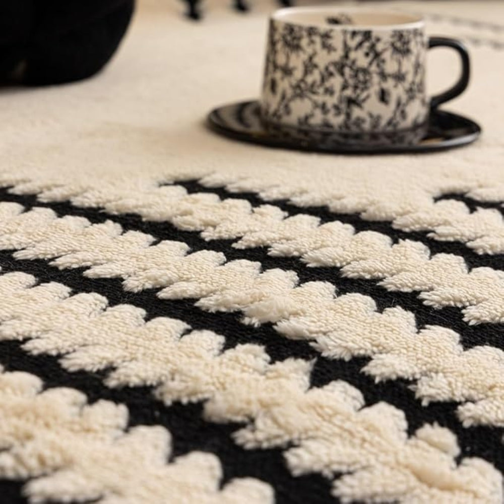 Close view of the raised tufted rows on the ivory cover beside a cup