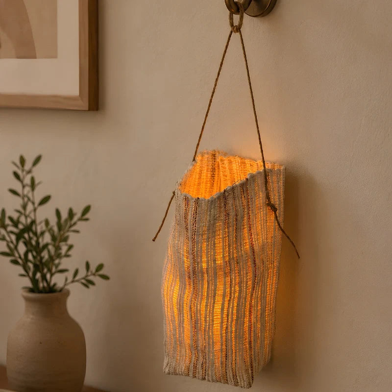 Vejle lantern hanging from a wall hook by its handle