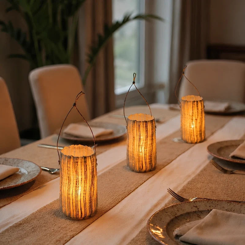 Three Vejle lanterns down the middle of a dining table