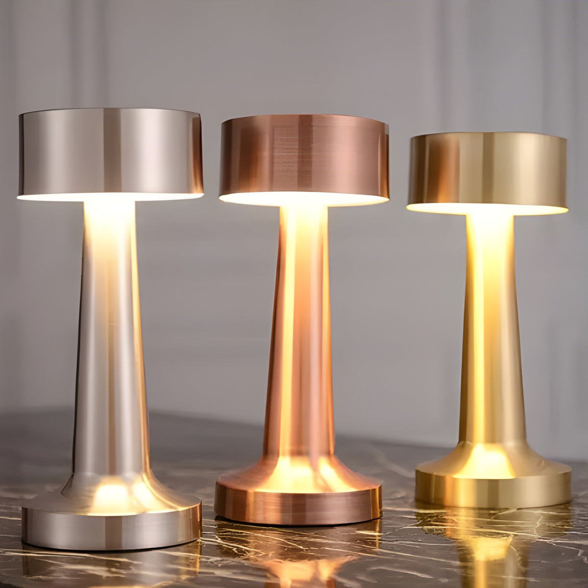 Venla cordless table lamps in silver, rose gold and gold, lit side by side