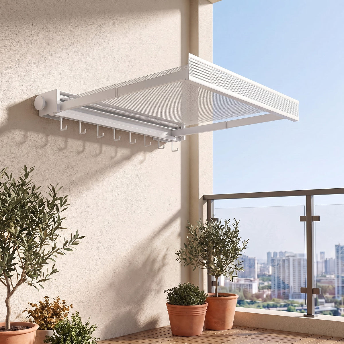 Wall drying rack in White with the mesh shelf pulled out on a balcony wall