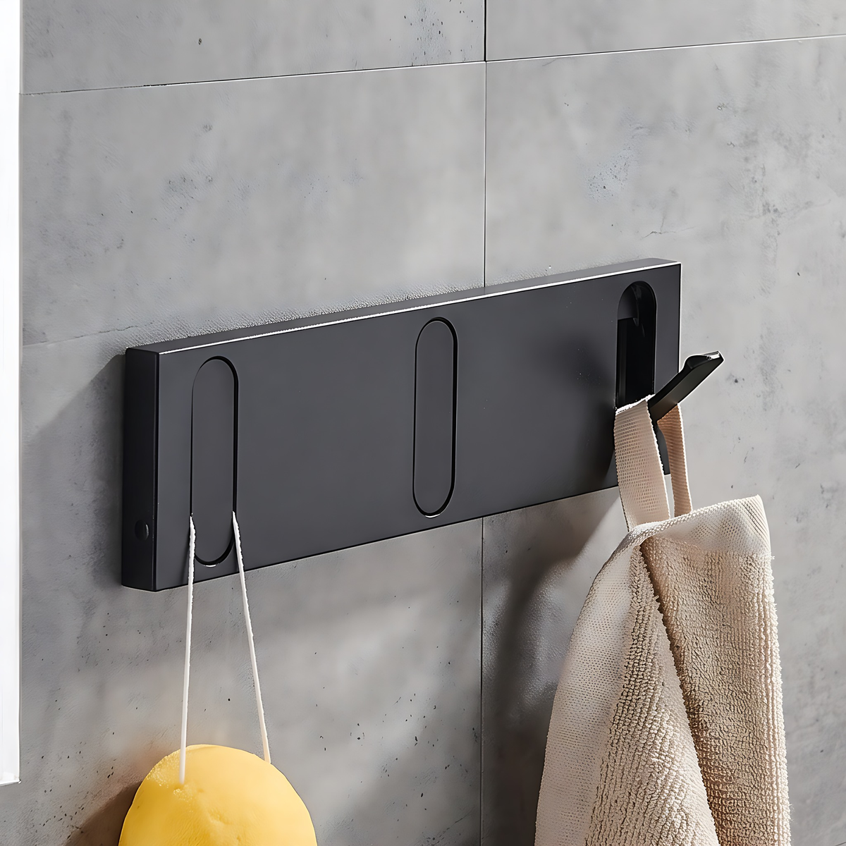 Black wall hook rack, 3 hooks, 9.4", on a warm plaster wall