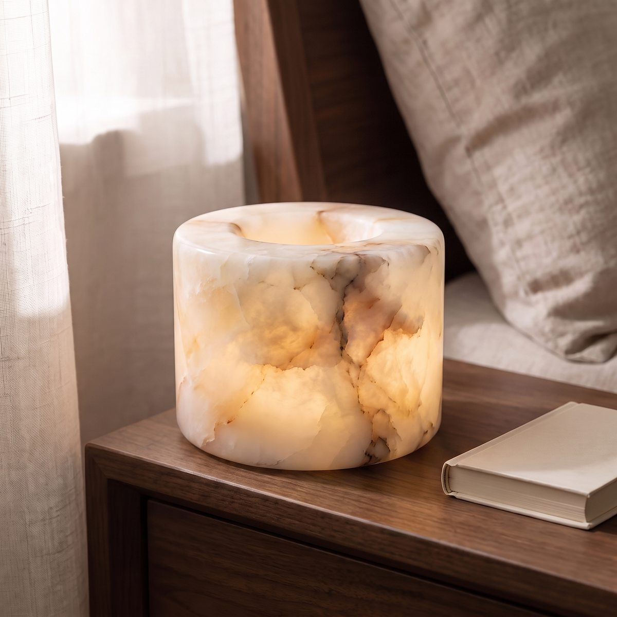 Ystad marble lamp in Honey marble glowing on a walnut nightstand