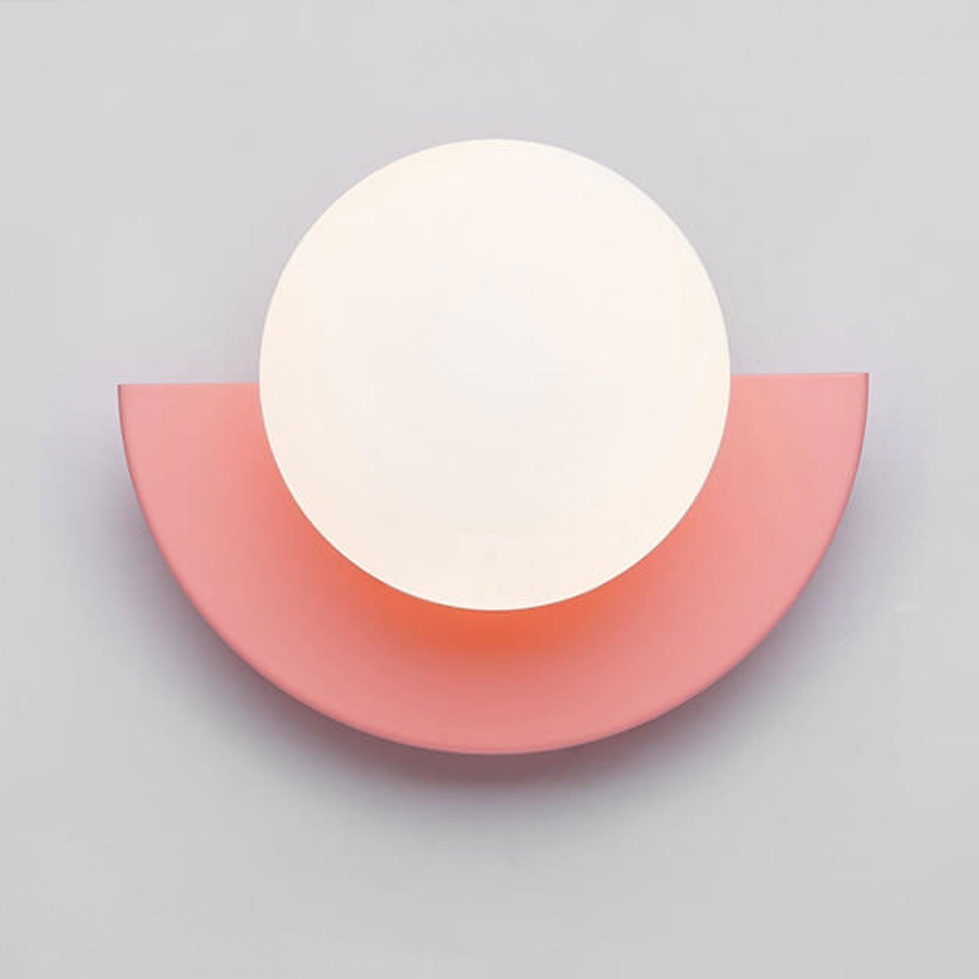 Yellow glass sphere wall sconce detail, iron frame close-up