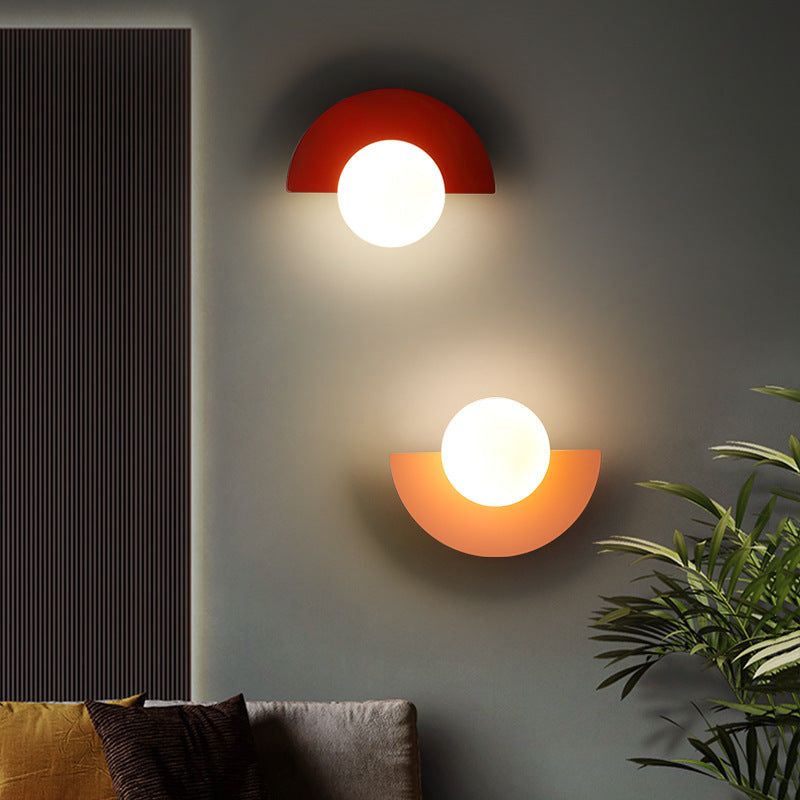 Spherical glass wall lamp with iron base, side profile view