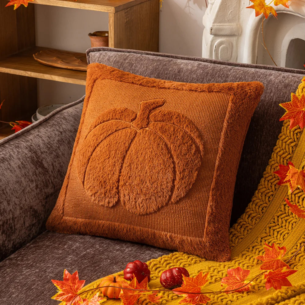 Rust pumpkin pillow cover on a gray sofa with a mustard throw