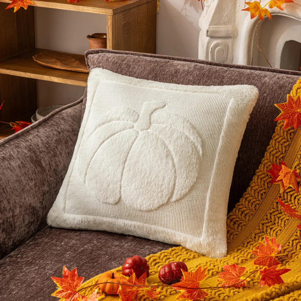 White pumpkin pillow cover on a gray sofa with a mustard throw