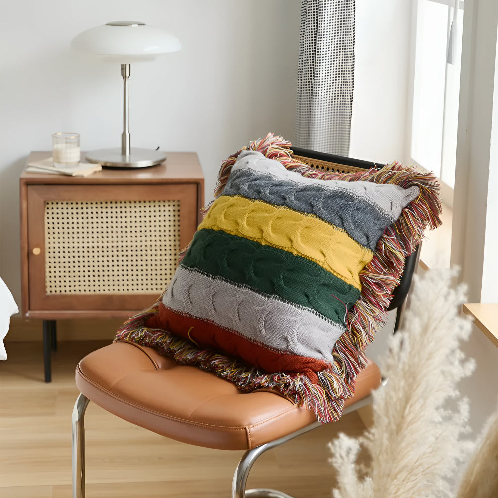 Striped cable knit cushion on a leather chair