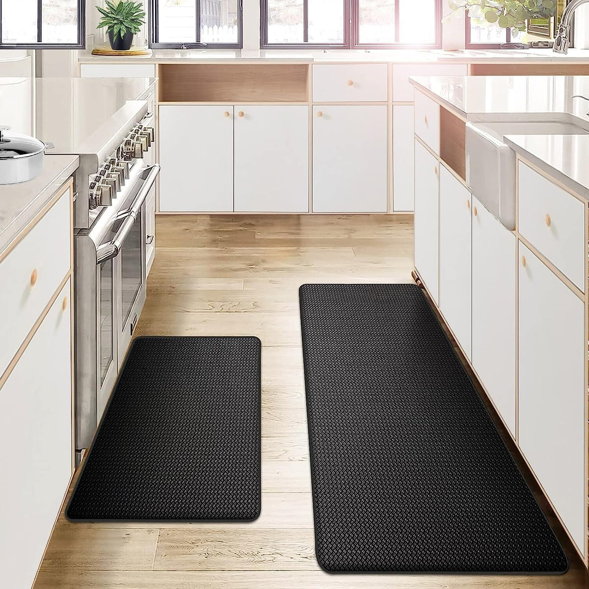 Two black anti fatigue mats by a range and counter