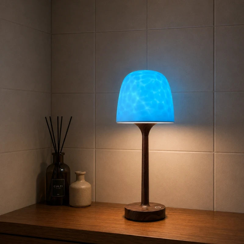 Arvika lamp glowing blue on a bathroom shelf