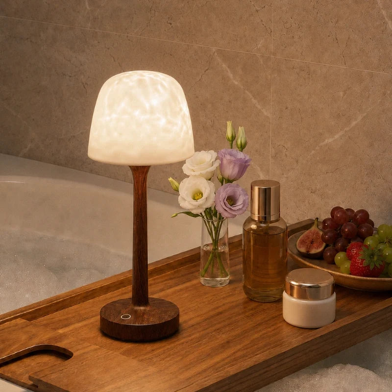 Arvika lamp glowing white on a bath tray with flowers
