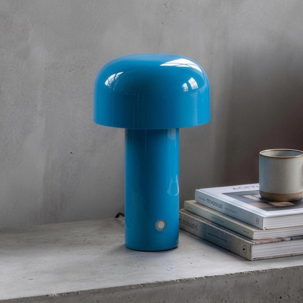 Britta dome table lamp in blue on a concrete nightstand