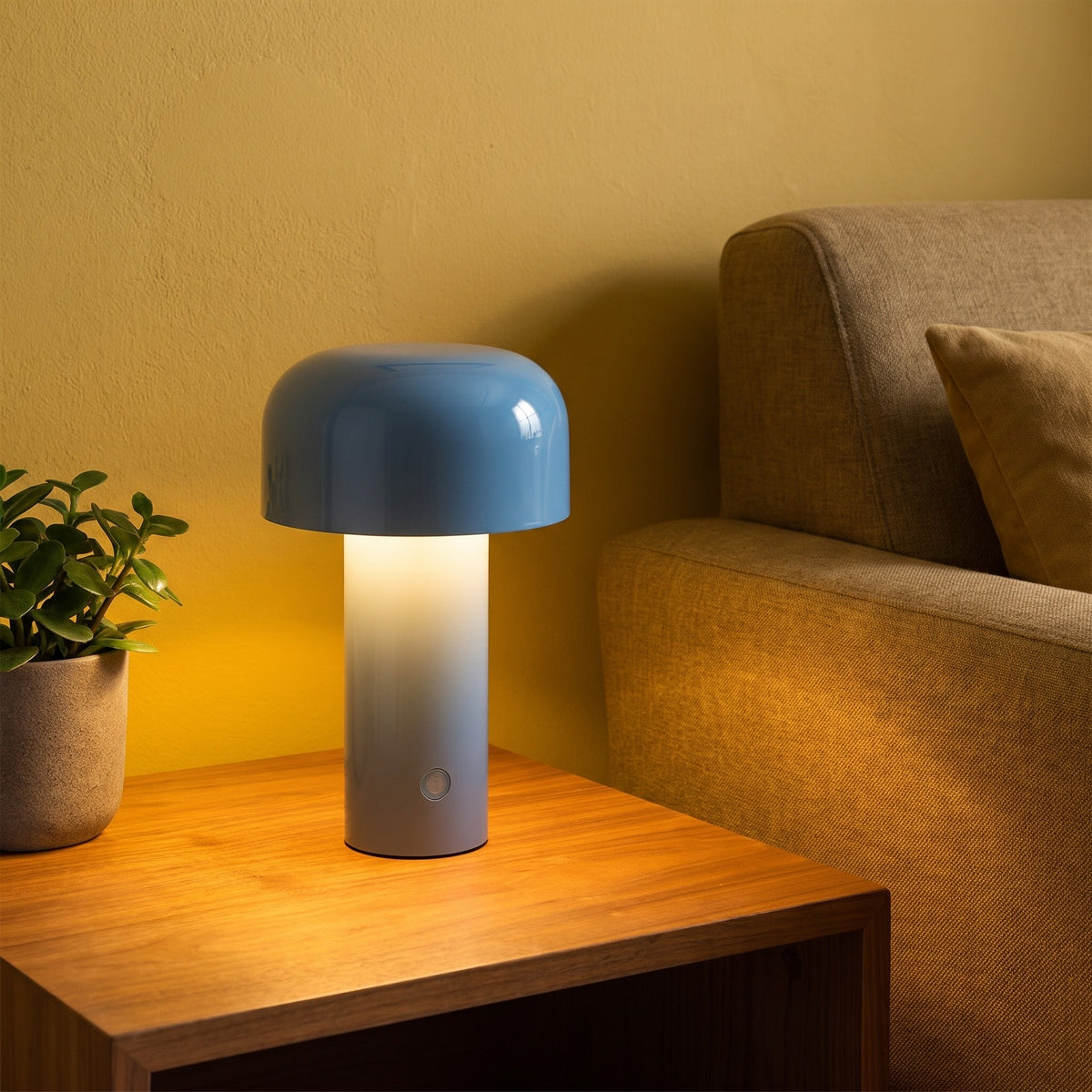 Britta dome table lamp in silver gray, lit on a side table by a sofa