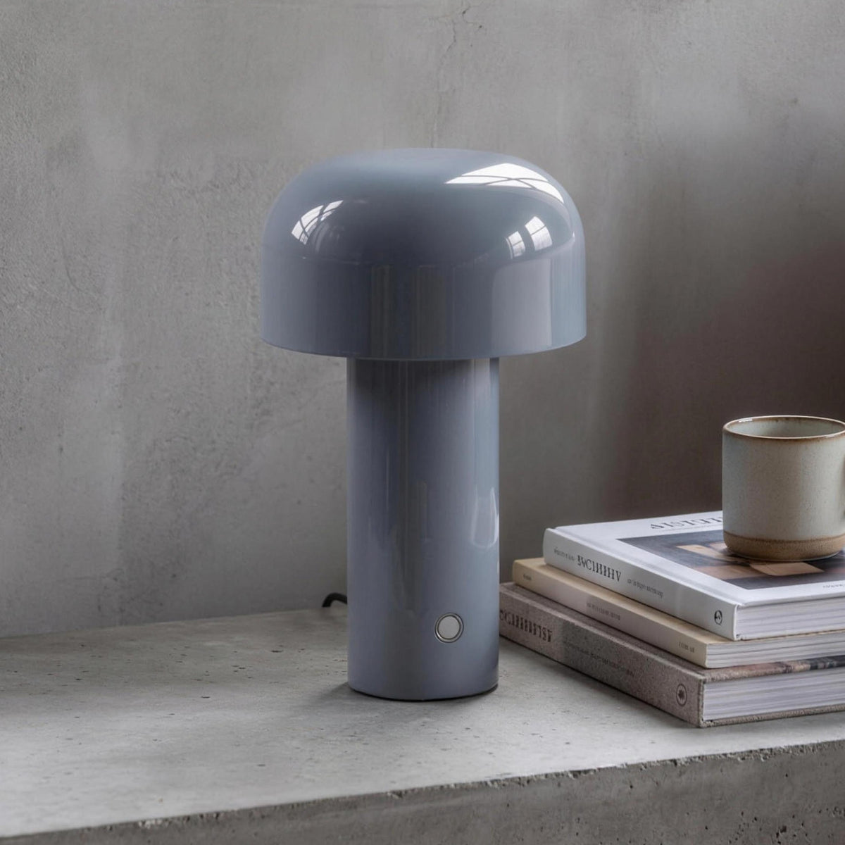Britta dome table lamp in silver gray on a concrete nightstand