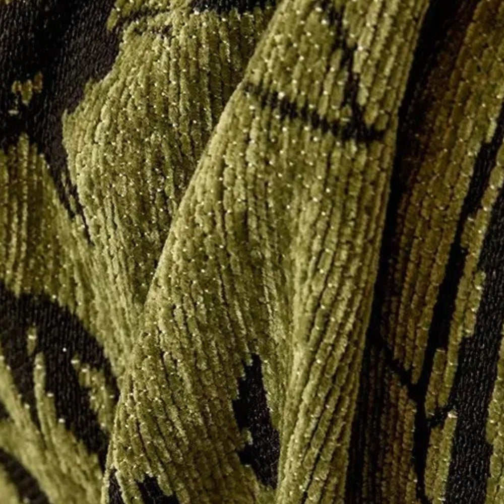 Close up of the soft olive green chenille pile and the black jacquard pattern of the sofa cover