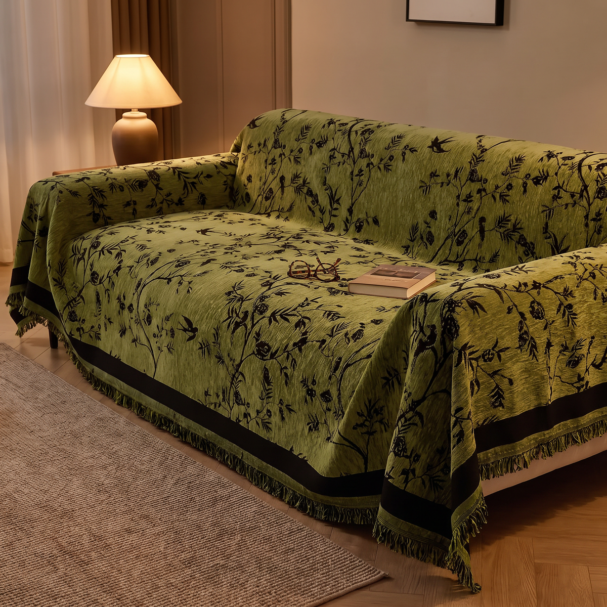 Chenille sofa cover with a tassel edge on a sofa in a lamp lit lounge in the evening