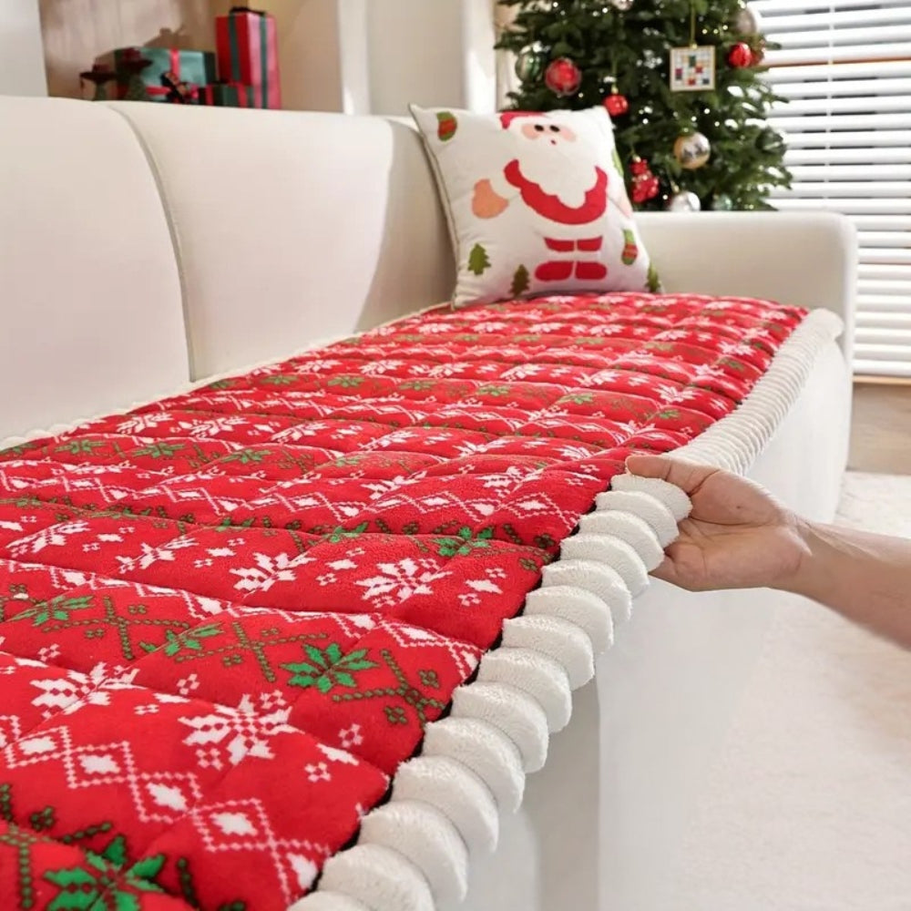 Hand lifting the edge of the red holiday seat pad to show its thickness and plush edge