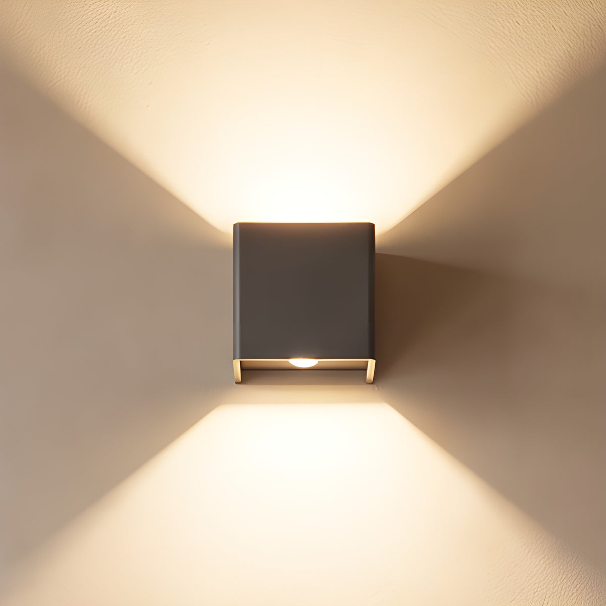 Cube outdoor wall light lighting a plaster wall up and down beside a staircase