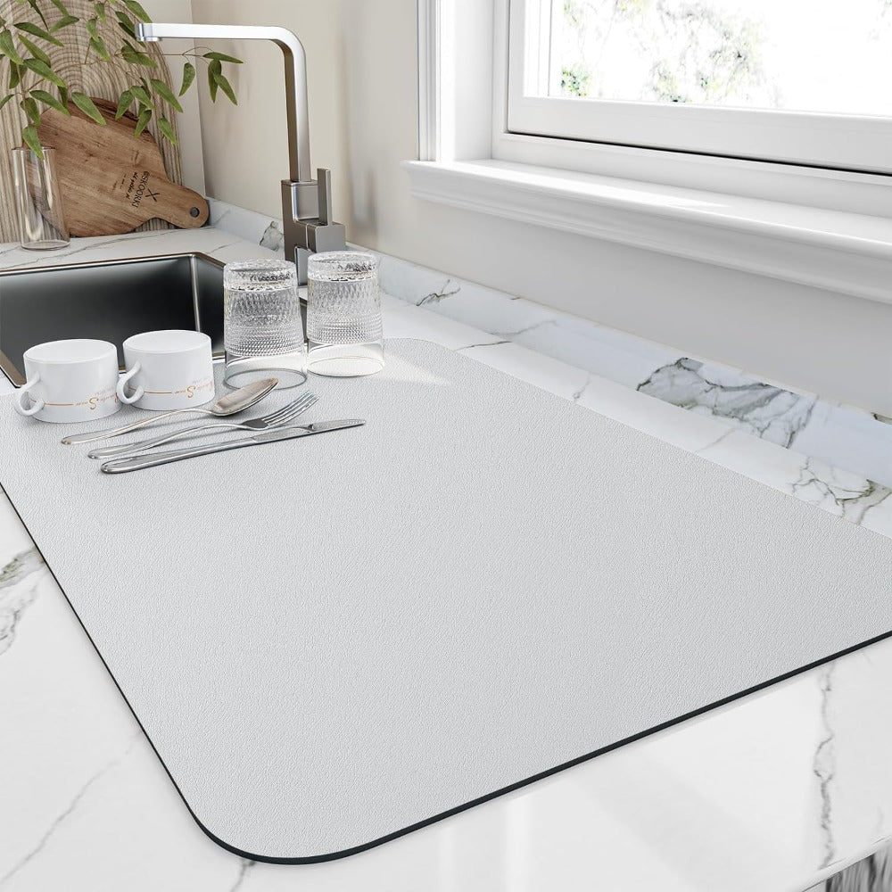 White dish drying mat by a sink