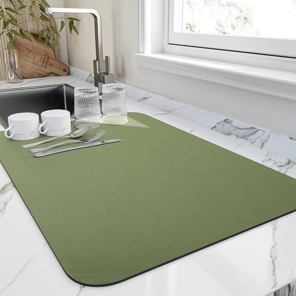 Green dish drying mat by a sink