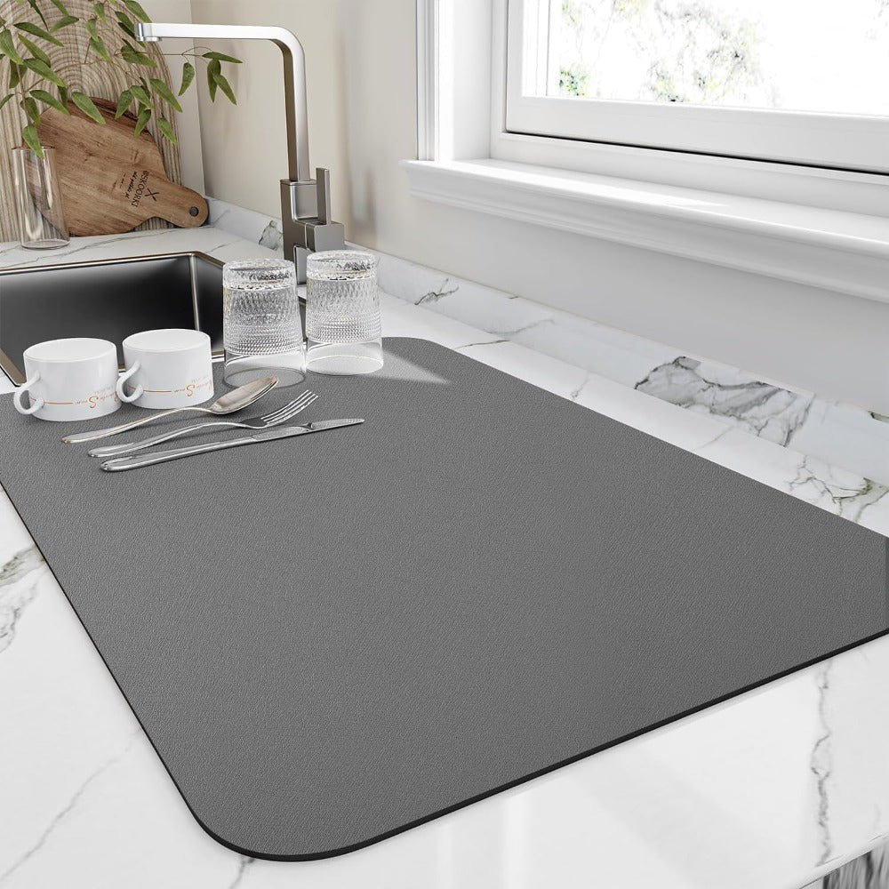 Dark gray dish drying mat by a sink