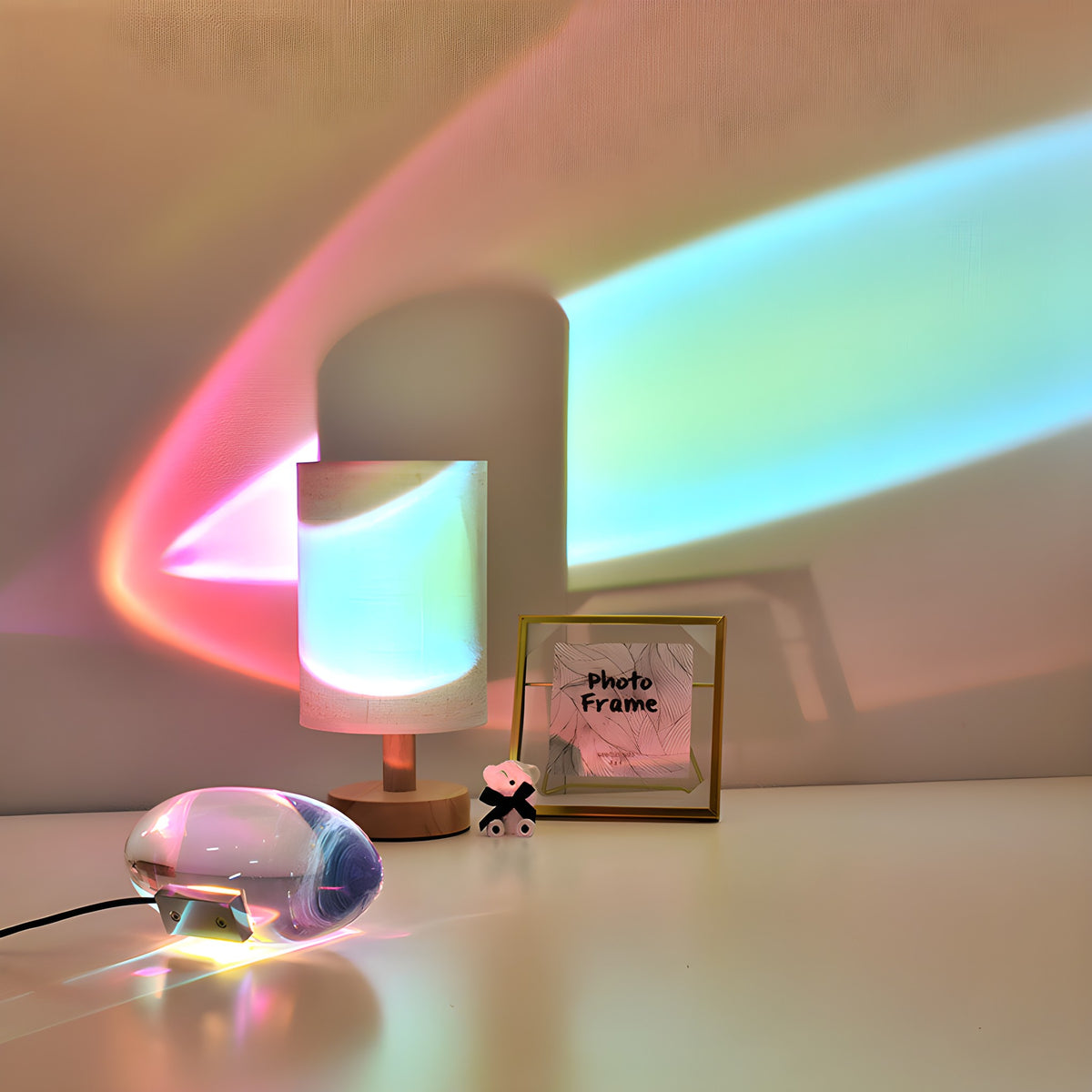 Elna projection lamp throwing colored light behind a photo frame