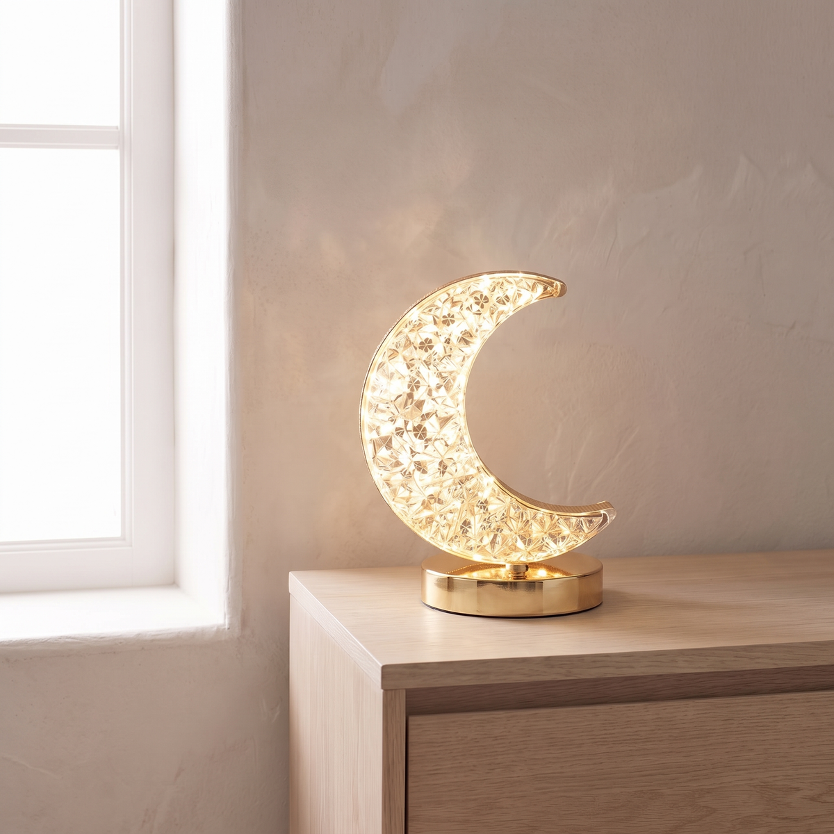 Elva crescent moon night light glowing on an oak nightstand