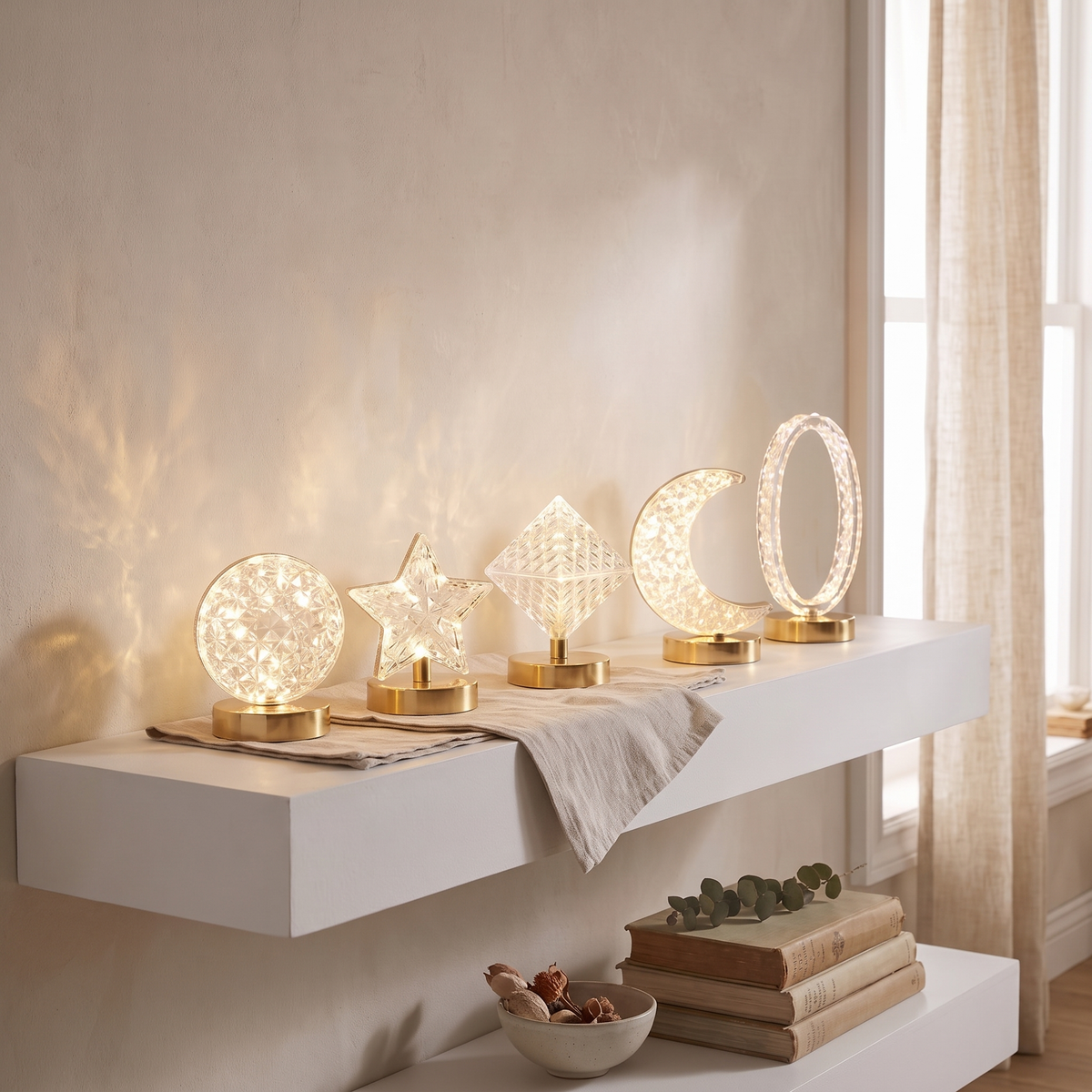 Elva night lights in round, star, square, moon, and oval track shapes on a shelf