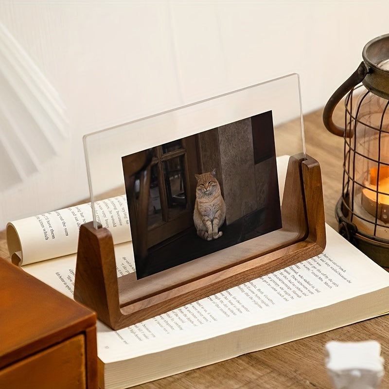 Fana walnut frame holding a photo of a cat, set on an open book beside a lantern