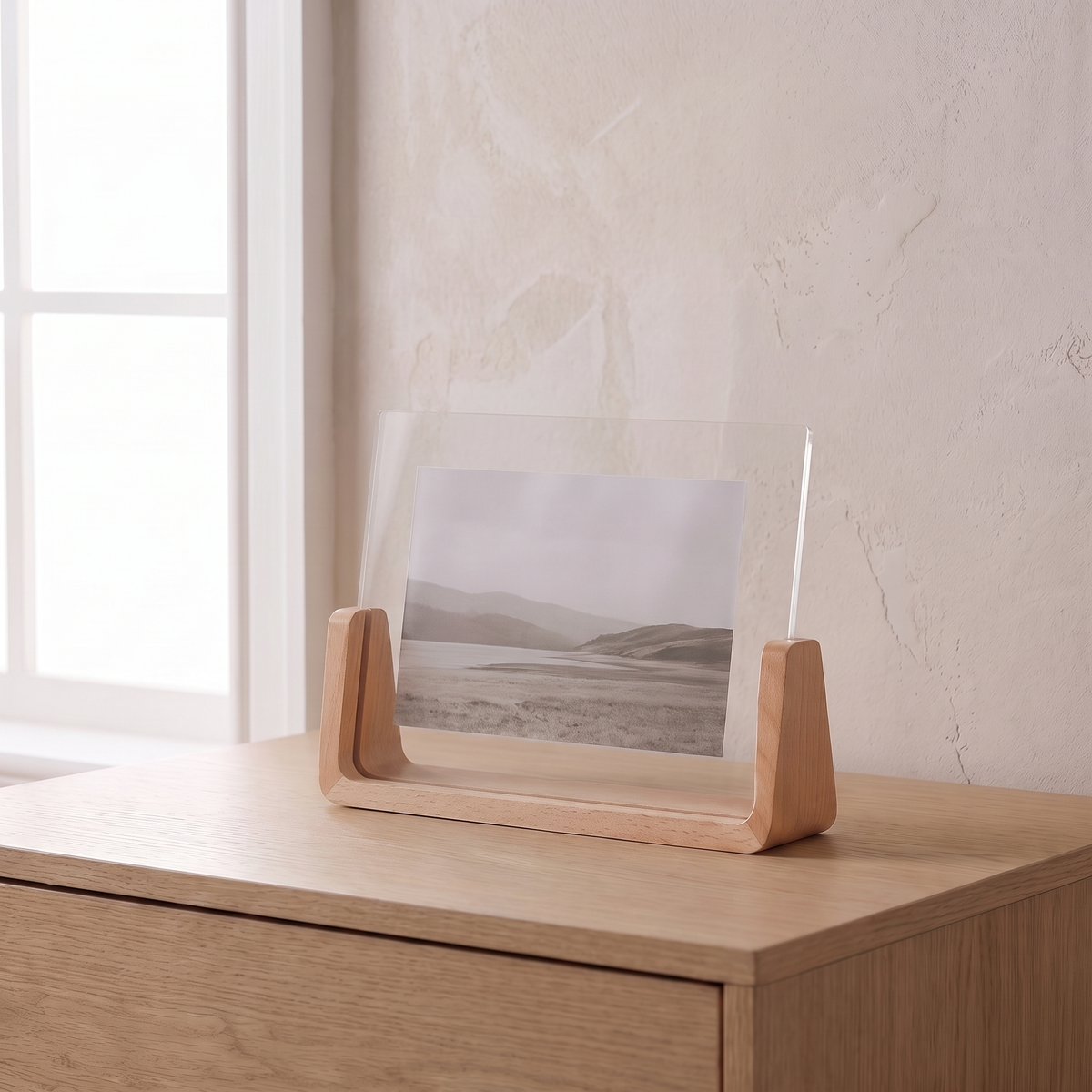 Fana frame, horizontal, beech wood, holding a landscape print on an oak dresser