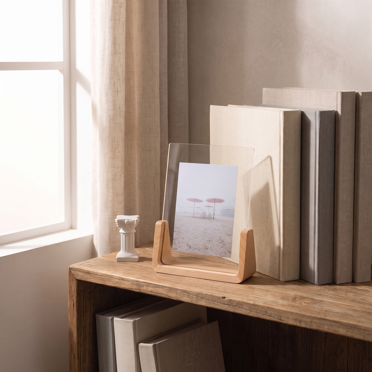 Fana frame on a bookshelf with the acrylic sleeve lifted from the wood base